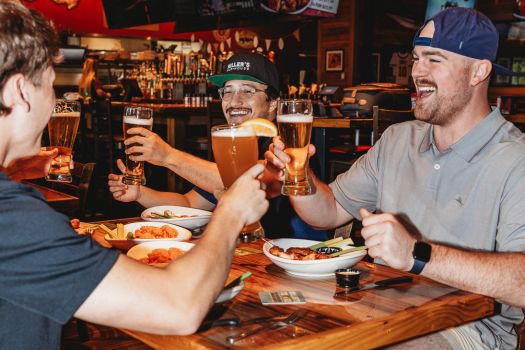 couple of guys hanging out at millers ale house enjoying some beers