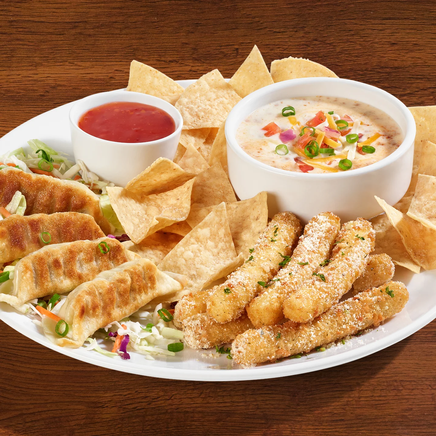 Starting 3 Sampler, potstickers, mozzarella sticks, chips and queso